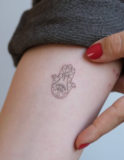 Fine line hamsa tattoo by Berkay Erkul @berkayerkul