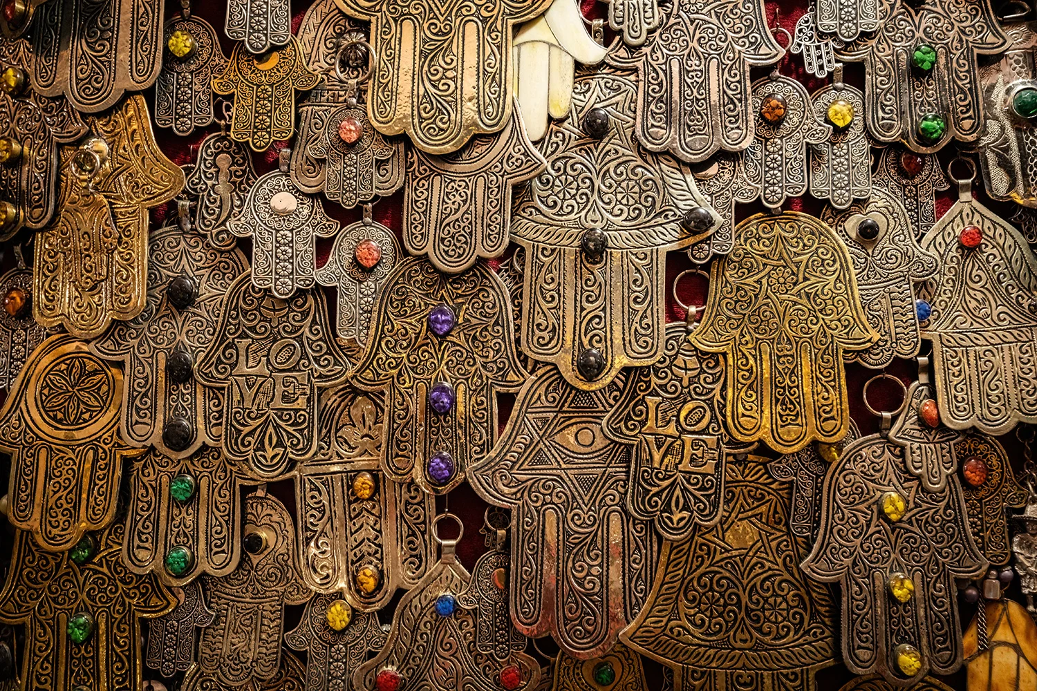 Hamsa (hands of Fatima) amulets in the gift shop in Morocco, via Adobe Stock